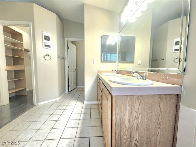 8220 Desert Beach Dr, Las Vegas, NV 89128 - full bathroom featuring double vanity, tile patterned floors, and a walk in closet