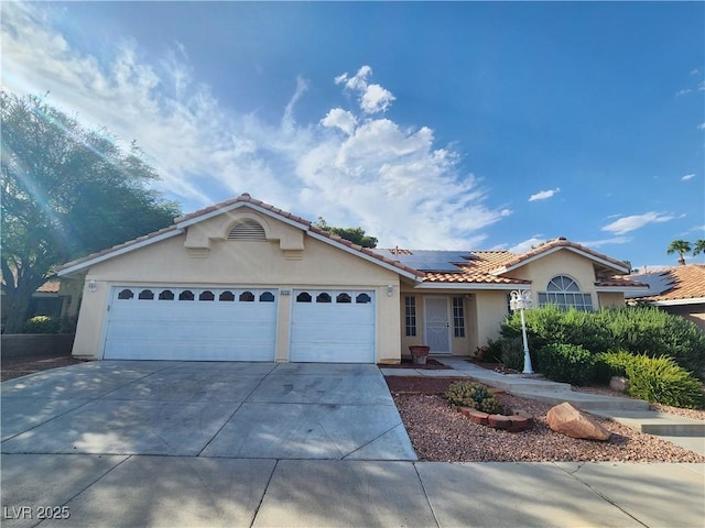 8220 Desert Beach Dr, Las Vegas, NV 89128 - ranch-style house with stucco siding, concrete driveway, a garage, roof mounted solar panels, and a tiled roof
