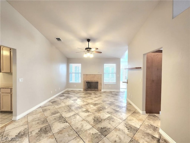 8220 Desert Beach Dr, Las Vegas, NV 89128 - unfurnished living room with ceiling fan, a tiled fireplace, and high vaulted ceiling
