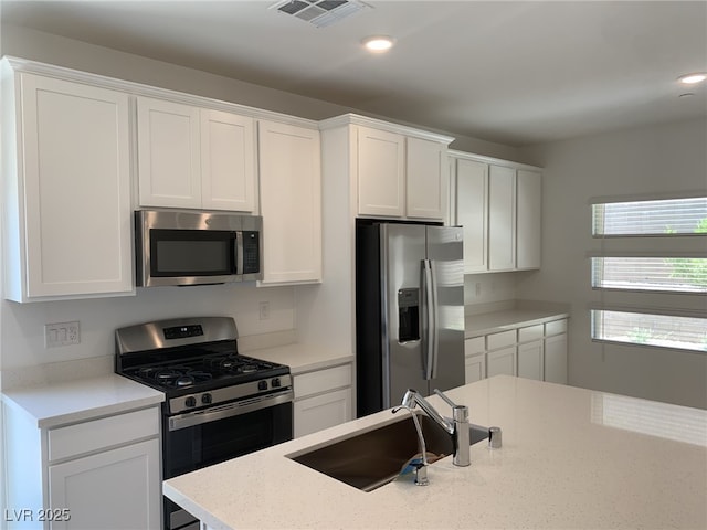 901 Heritage Bend Dr, Las Vegas, NV 89138 - kitchen featuring appliances with stainless steel finishes, white cabinets, recessed lighting, and light stone counters