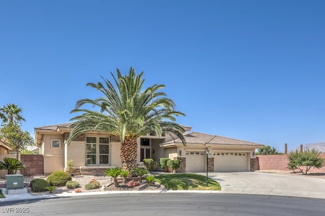 6821 Sleepy Pine St, Las Vegas, NV 89130 - view of front of property with concrete driveway, a garage, stone siding, and stucco siding