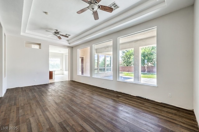 6821 Sleepy Pine St, Las Vegas, NV 89130 - unfurnished room featuring a tray ceiling, ceiling fan, and dark wood-style floors