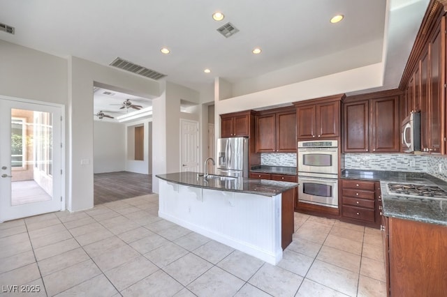 6821 Sleepy Pine St, Las Vegas, NV 89130 - kitchen with appliances with stainless steel finishes, light tile patterned floors, backsplash, and recessed lighting