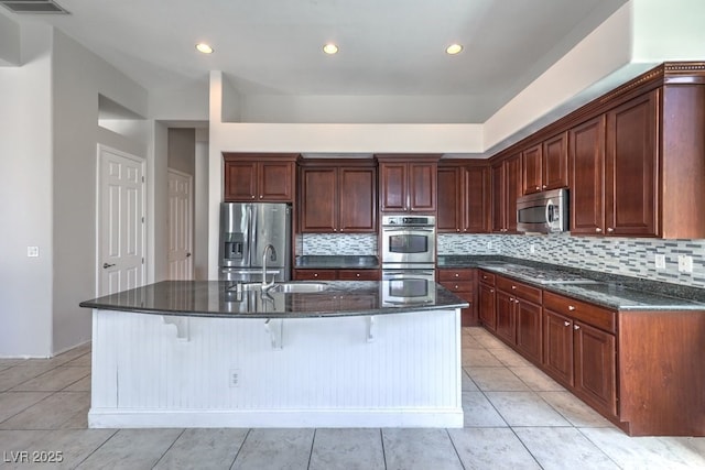 6821 Sleepy Pine St, Las Vegas, NV 89130 - kitchen featuring stainless steel appliances, backsplash, dark stone countertops, a breakfast bar, and recessed lighting