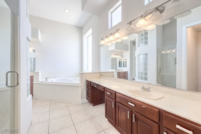 6821 Sleepy Pine St, Las Vegas, NV 89130 - bathroom featuring a shower stall, vanity, a garden tub, and tile patterned floors