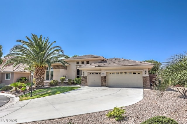 6821 Sleepy Pine St, Las Vegas, NV 89130 - view of front of house featuring an attached garage, driveway, stucco siding, and stone siding