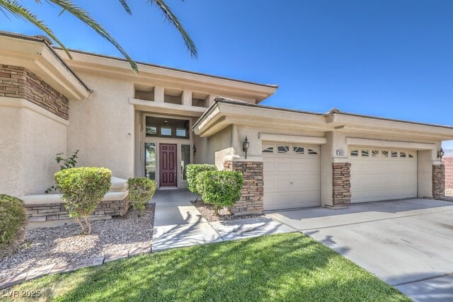 6821 Sleepy Pine St, Las Vegas, NV 89130 - view of front of home with stucco siding, a garage, driveway, and stone siding