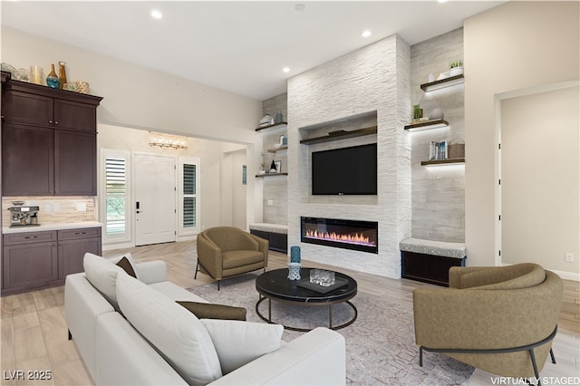 10179 Emerald Sunset Ct, Las Vegas, NV 89148 - living room with a fireplace, recessed lighting, light wood-style floors, and built in features