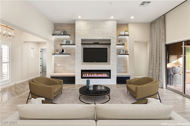 10179 Emerald Sunset Ct, Las Vegas, NV 89148 - living room with recessed lighting, a fireplace, and wood finished floors