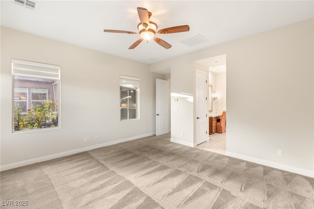 10179 Emerald Sunset Ct, Las Vegas, NV 89148 - unfurnished bedroom with light carpet, ensuite bath, and ceiling fan