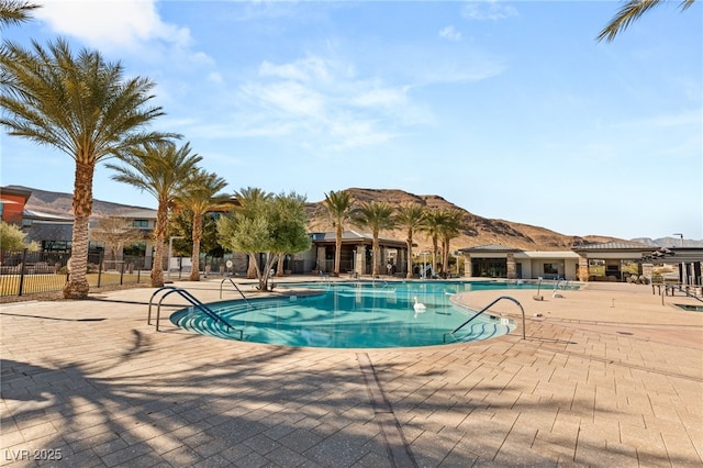 10179 Emerald Sunset Ct, Las Vegas, NV 89148 - community pool with a patio area and a mountain view
