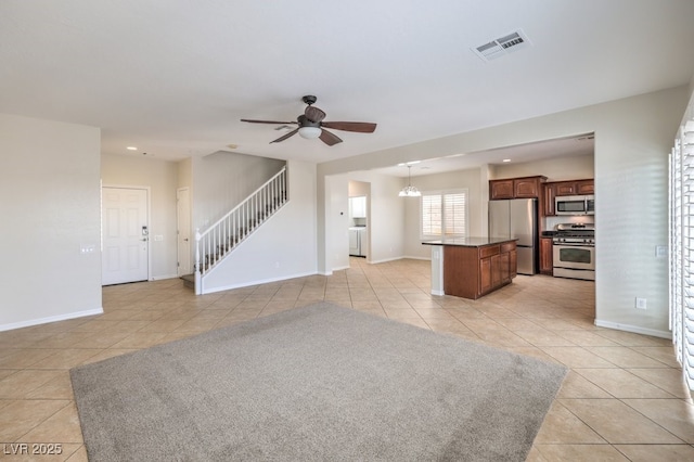 1064 Calvia St, Las Vegas, NV 89138 - unfurnished living room featuring light tile patterned floors, a ceiling fan, stairway, recessed lighting, and washer / dryer