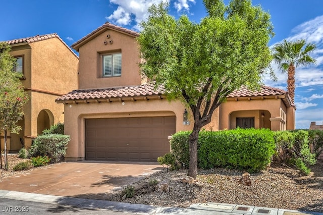 1064 Calvia St, Las Vegas, NV 89138 - mediterranean / spanish-style home featuring a tile roof, concrete driveway, an attached garage, and stucco siding
