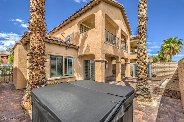 1064 Calvia St, Las Vegas, NV 89138 - rear view of property with stucco siding, a tiled roof, and a hot tub