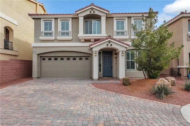 8176 Duncan Peak Ct, Las Vegas, NV 89139 - view of front facade with stucco siding, a tiled roof, an attached garage, and decorative driveway