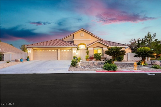 6617 Golden Bit Ave, Las Vegas, NV 89131 - mediterranean / spanish-style home featuring a tiled roof, a garage, stucco siding, and concrete driveway