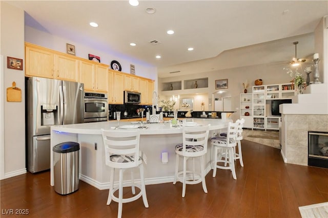 6617 Golden Bit Ave, Las Vegas, NV 89131 - kitchen featuring stainless steel appliances, light brown cabinets, a large island, dark wood-style flooring, and recessed lighting