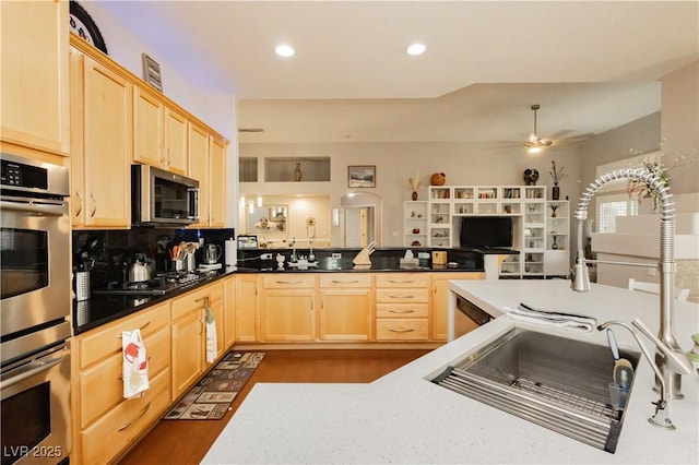6617 Golden Bit Ave, Las Vegas, NV 89131 - kitchen with light brown cabinetry, appliances with stainless steel finishes, a ceiling fan, open floor plan, and recessed lighting