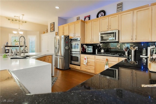 6617 Golden Bit Ave, Las Vegas, NV 89131 - kitchen featuring appliances with stainless steel finishes, light brown cabinets, dark wood-style floors, and recessed lighting