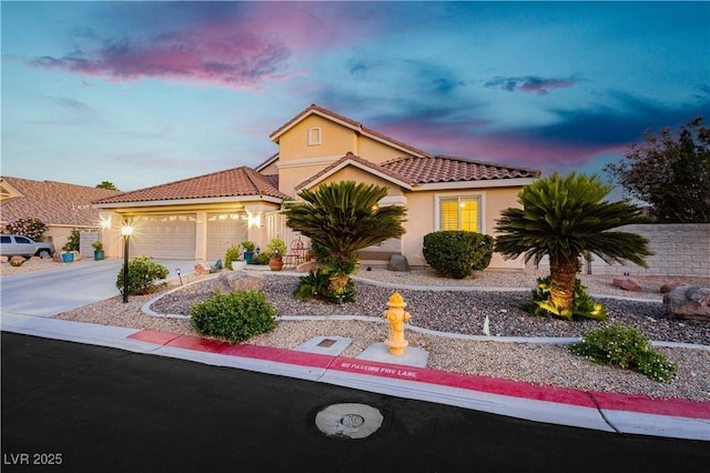 6617 Golden Bit Ave, Las Vegas, NV 89131 - mediterranean / spanish home featuring stucco siding, a tiled roof, concrete driveway, and an attached garage