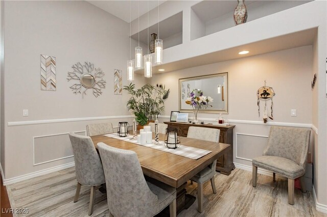 6617 Golden Bit Ave, Las Vegas, NV 89131 - dining space featuring light wood finished floors, a chandelier, recessed lighting, and a high ceiling