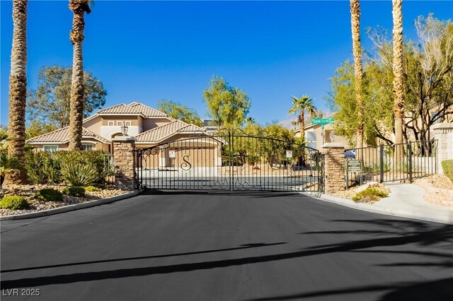 6617 Golden Bit Ave, Las Vegas, NV 89131 - view of asphalt street featuring a gate, a gated entry, and curbs