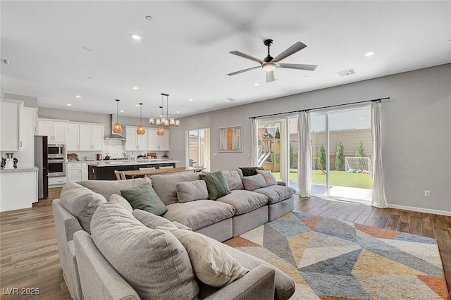 10161 Bismarck Palms Ave, Las Vegas, NV 89166 - living room featuring healthy amount of natural light, recessed lighting, wood finished floors, and ceiling fan
