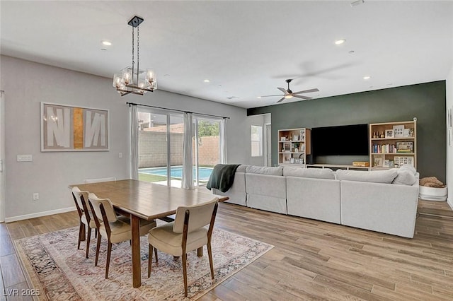 10161 Bismarck Palms Ave, Las Vegas, NV 89166 - dining space featuring recessed lighting, light wood-style floors, a ceiling fan, and a chandelier