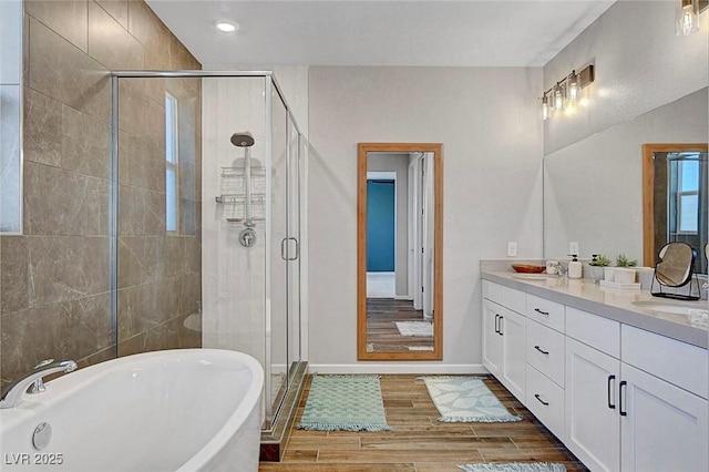 10161 Bismarck Palms Ave, Las Vegas, NV 89166 - bathroom featuring vanity, a freestanding bath, a stall shower, wood finished floors, and recessed lighting
