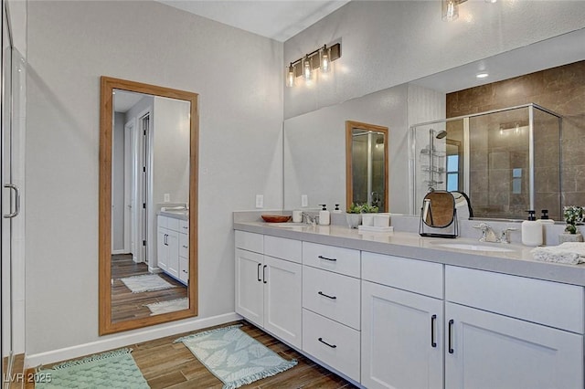 10161 Bismarck Palms Ave, Las Vegas, NV 89166 - full bath featuring double vanity, a stall shower, and wood finished floors