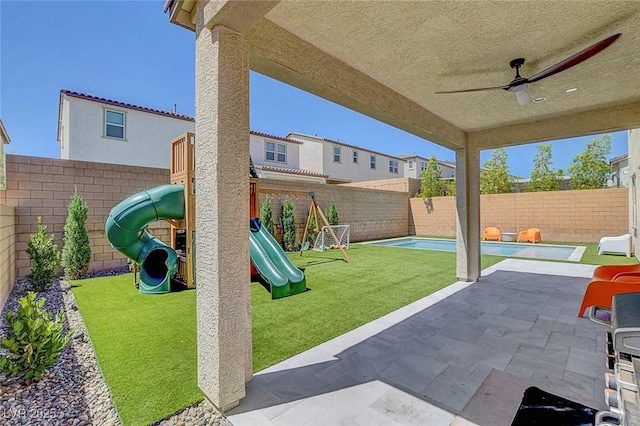 10161 Bismarck Palms Ave, Las Vegas, NV 89166 - fenced backyard featuring a playground, a patio area, and a ceiling fan