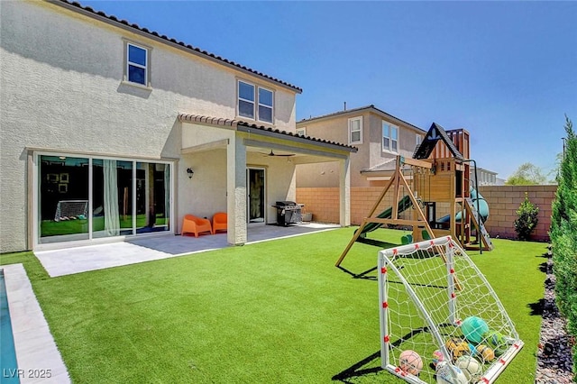 10161 Bismarck Palms Ave, Las Vegas, NV 89166 - back of property featuring a playground, a patio area, a fenced backyard, and stucco siding