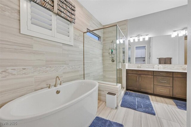 5801 Exbury Gardens Ct, Las Vegas, NV 89118 - bathroom featuring a freestanding tub, a stall shower, vanity, tile walls, and tile patterned floors