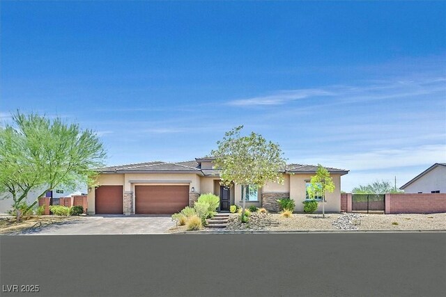 5801 Exbury Gardens Ct, Las Vegas, NV 89118 - view of front of house featuring a garage, stucco siding, driveway, and stone siding
