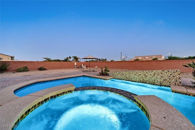 5801 Exbury Gardens Ct, Las Vegas, NV 89118 - view of swimming pool with a fenced backyard and a pool with connected hot tub