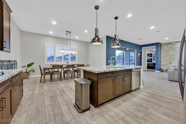 5801 Exbury Gardens Ct, Las Vegas, NV 89118 - kitchen with dishwasher, light wood finished floors, a kitchen island with sink, pendant lighting, and recessed lighting