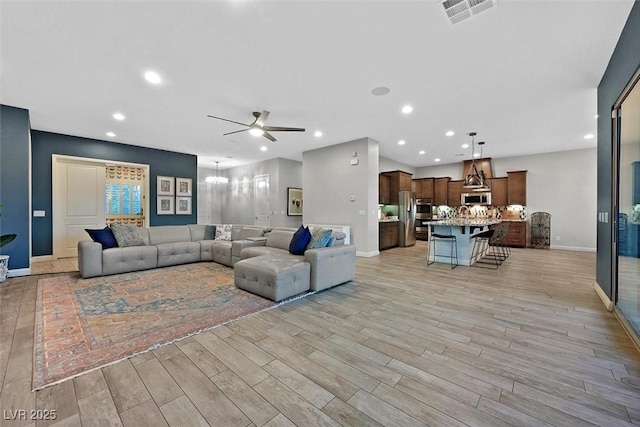 5801 Exbury Gardens Ct, Las Vegas, NV 89118 - living room with a ceiling fan, light wood finished floors, recessed lighting, and a chandelier
