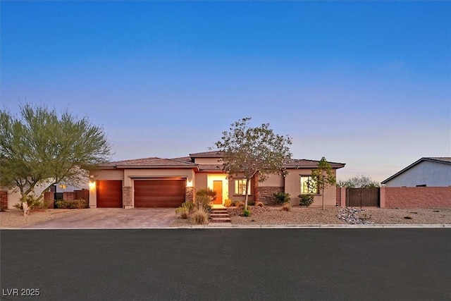 5801 Exbury Gardens Ct, Las Vegas, NV 89118 - prairie-style house with an attached garage, driveway, and stucco siding