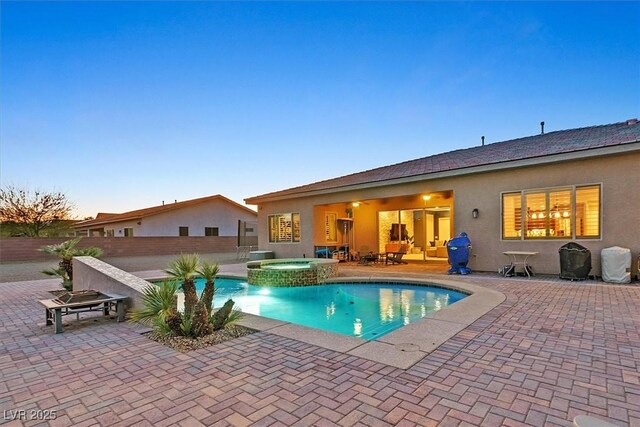 5801 Exbury Gardens Ct, Las Vegas, NV 89118 - pool at dusk featuring a patio area and a pool with connected hot tub
