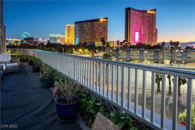 360 E Desert Inn Rd Unit 407, Las Vegas, NV 89109 - balcony at dusk featuring a view of city