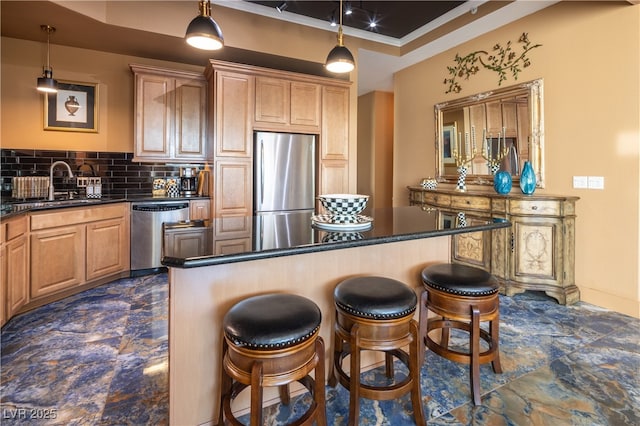 360 E Desert Inn Rd Unit 407, Las Vegas, NV 89109 - kitchen with stainless steel appliances, dark countertops, a breakfast bar area, and tasteful backsplash