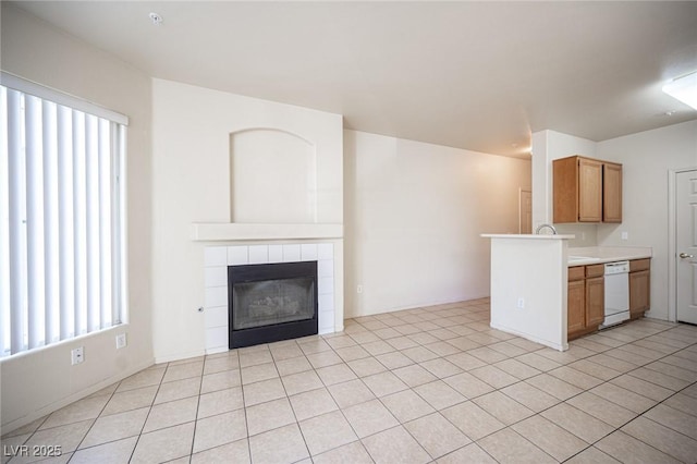 7155 S Durango Dr Unit 205, Las Vegas, NV 89113 - unfurnished living room with plenty of natural light, a fireplace, and light tile patterned floors