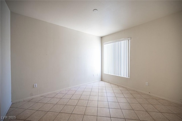 7155 S Durango Dr Unit 205, Las Vegas, NV 89113 - unfurnished room with baseboards and light tile patterned flooring