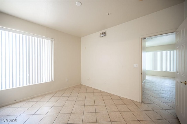 7155 S Durango Dr Unit 205, Las Vegas, NV 89113 - unfurnished room featuring plenty of natural light and light tile patterned floors