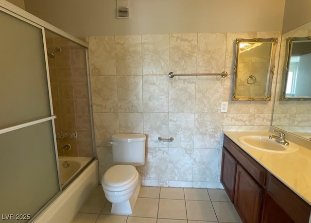 745 N Royal Crest Cir Unit 157, Las Vegas, NV 89169 - bathroom featuring vanity, combined bath / shower with glass door, tile patterned flooring, and tile walls