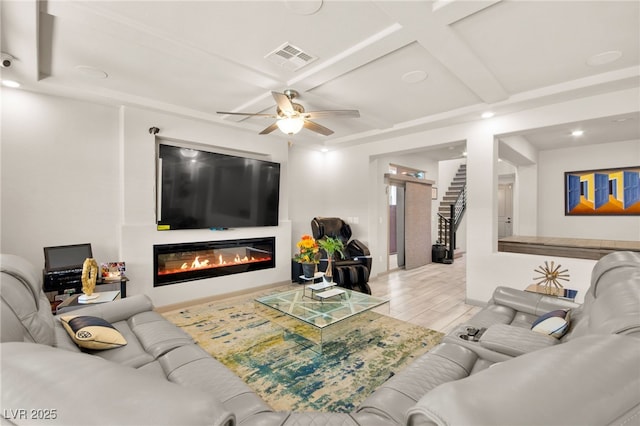 8955 Ruby Moon Dr, Las Vegas, NV 89139 - living area with a glass covered fireplace, ceiling fan, coffered ceiling, wood finished floors, and recessed lighting