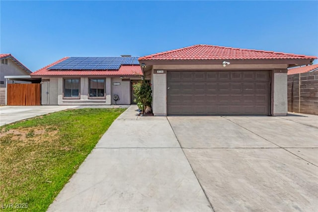 5734 Duval Dr, Las Vegas, NV 89156 - view of front of property with stucco siding, roof mounted solar panels, a tile roof, concrete driveway, and a garage