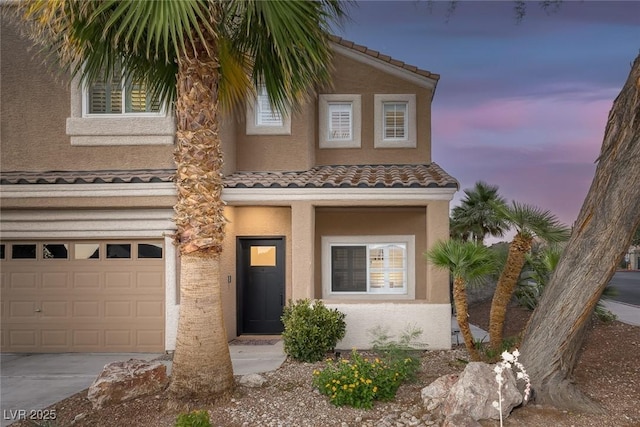 1246 Diamond Valley St, Henderson, NV 89052 - view of front of house featuring a garage, stucco siding, driveway, and a tiled roof