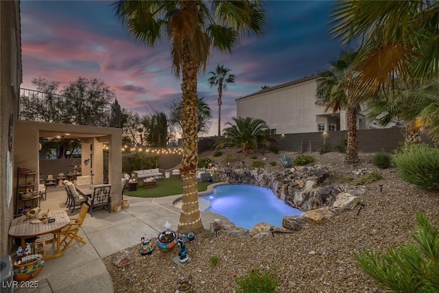 1246 Diamond Valley St, Henderson, NV 89052 - pool at dusk with outdoor lounge area, a fenced backyard, a patio area, and an outdoor pool