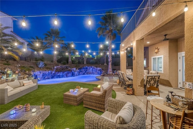 1246 Diamond Valley St, Henderson, NV 89052 - patio at night featuring an outdoor living space, a patio area, outdoor dining area, a yard, and an outdoor pool